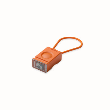 alt="Bloc lumière orange pour cycliste - design compact et lumineux"